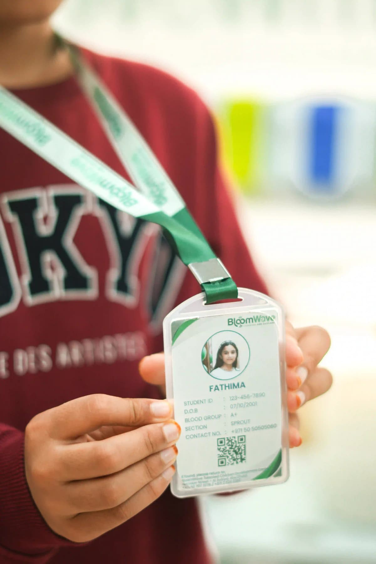 BloomWave student showing their daycare identification card
